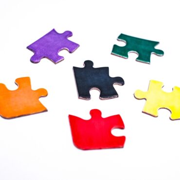 A,Collection,Of,Coloured,Jigsaw,Puzzle,Pieces,Scattered,On,A